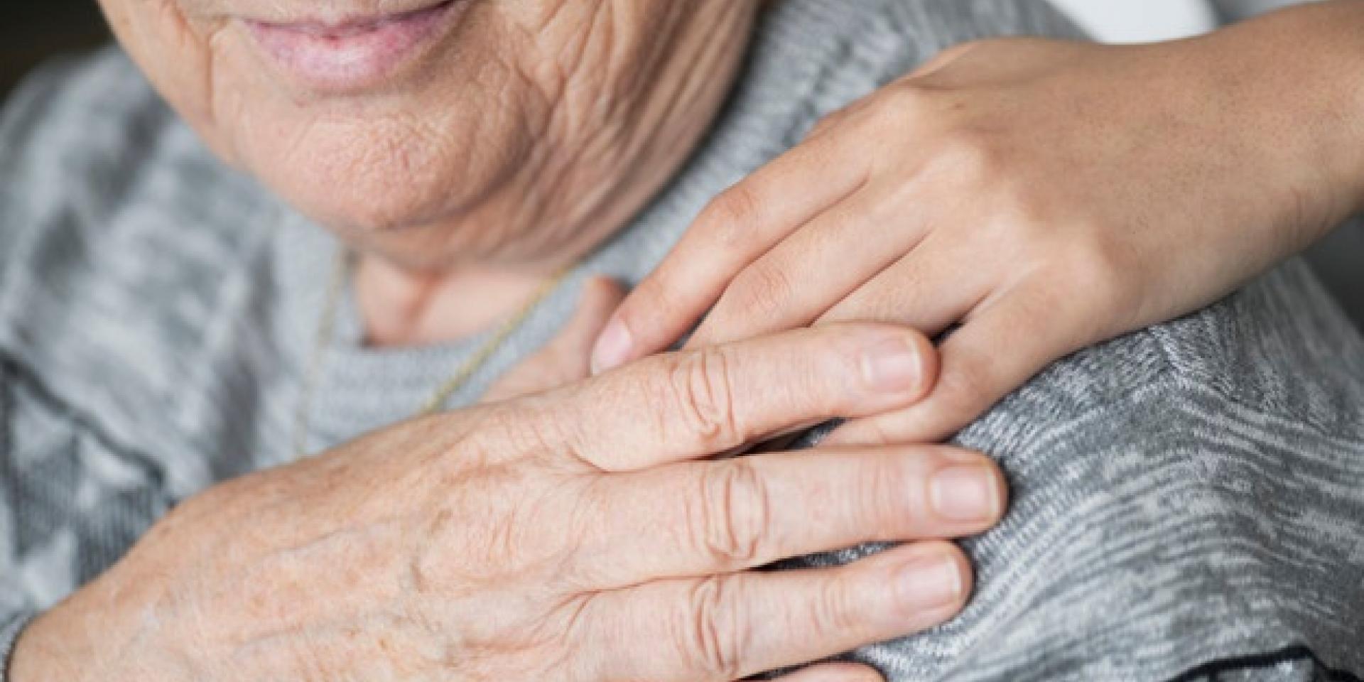 Person putting hand on another person's shoulder