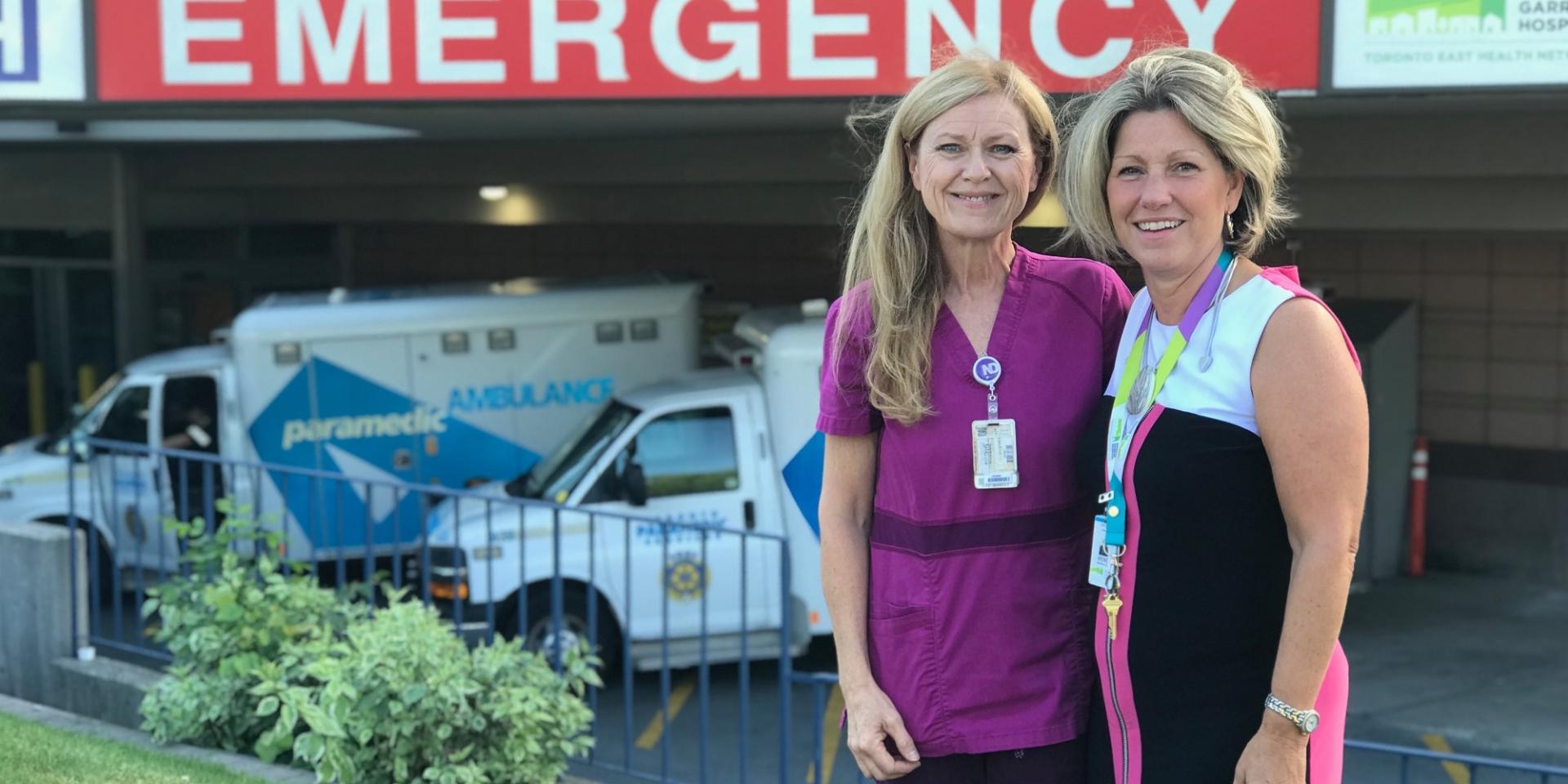 Colleen Young and Irene Andress stand in front of MGH's Emergency Department.