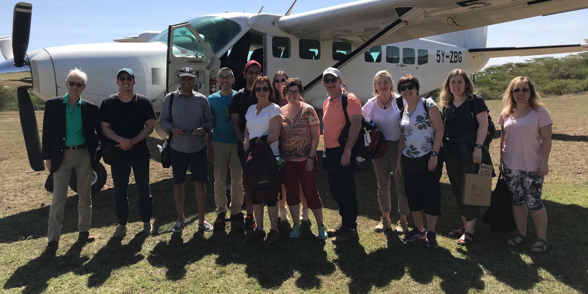 Team in front of airplane