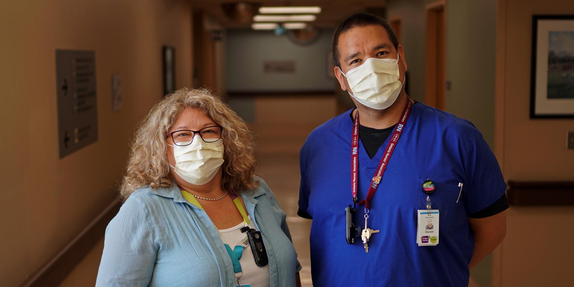 Photo of Kim Kurschinski and Daniel Chilton wearing masks