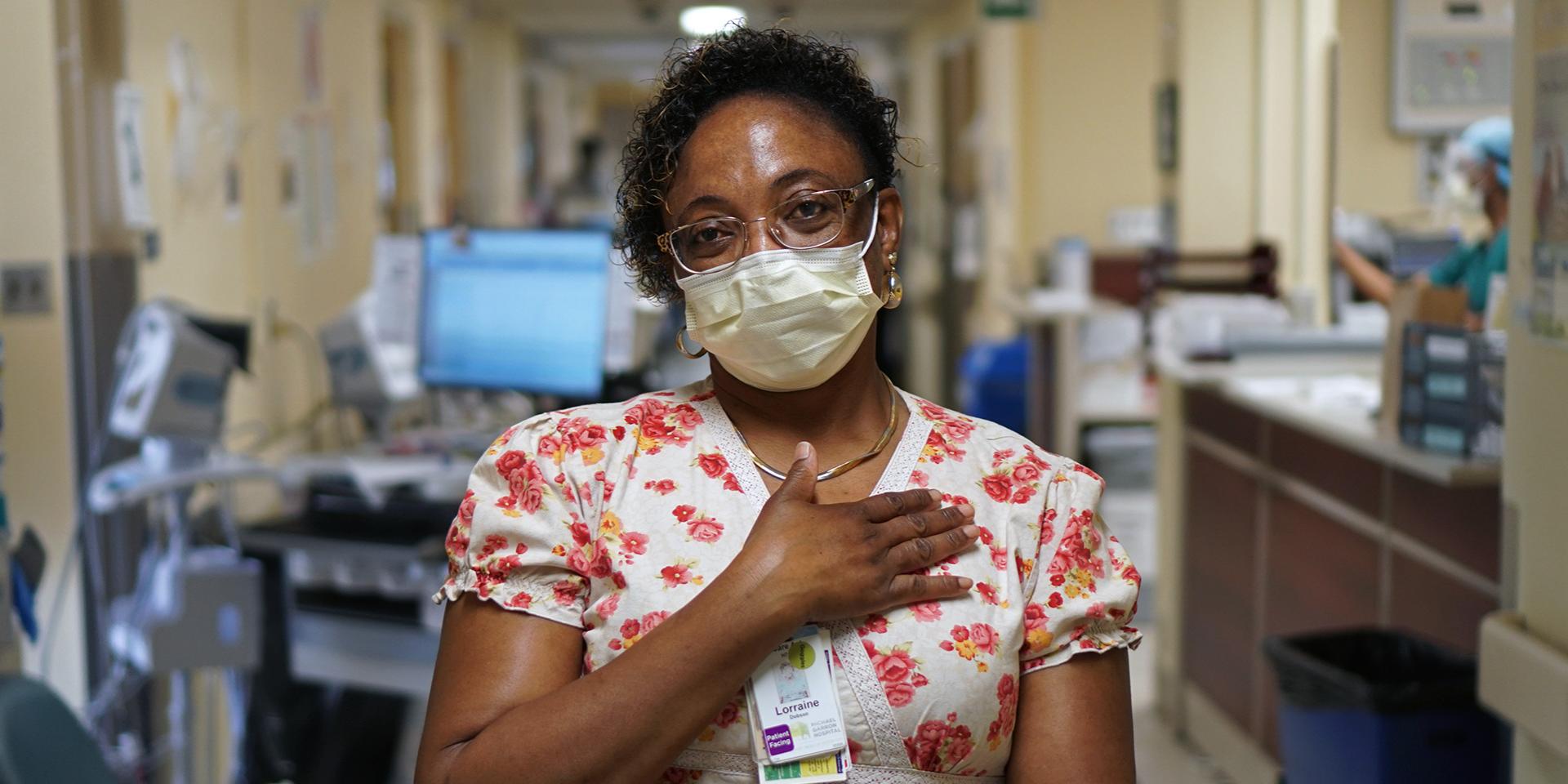 Lorraine Dobson standing with hand on her heart