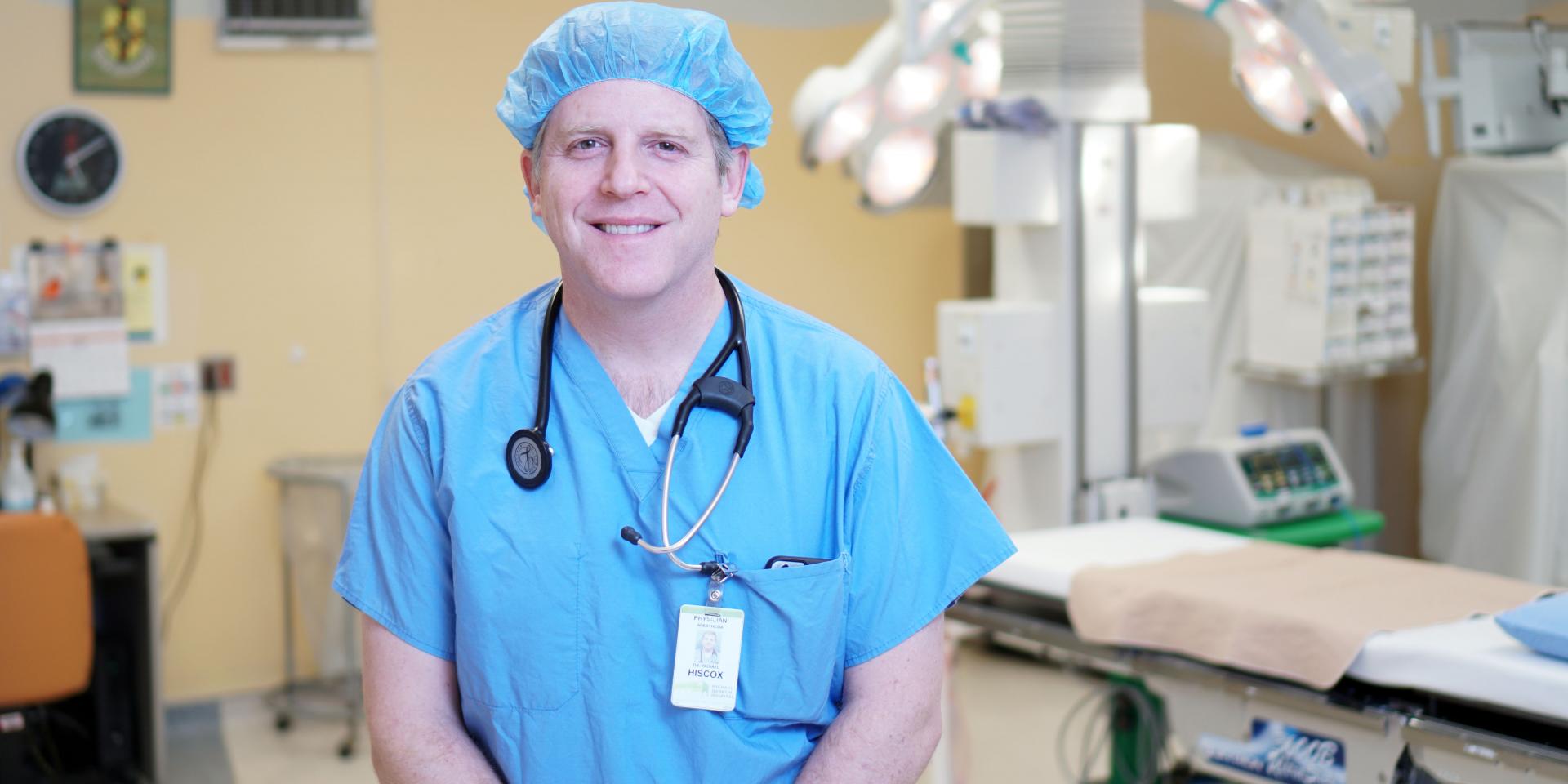 Doctor stands in an operating room.