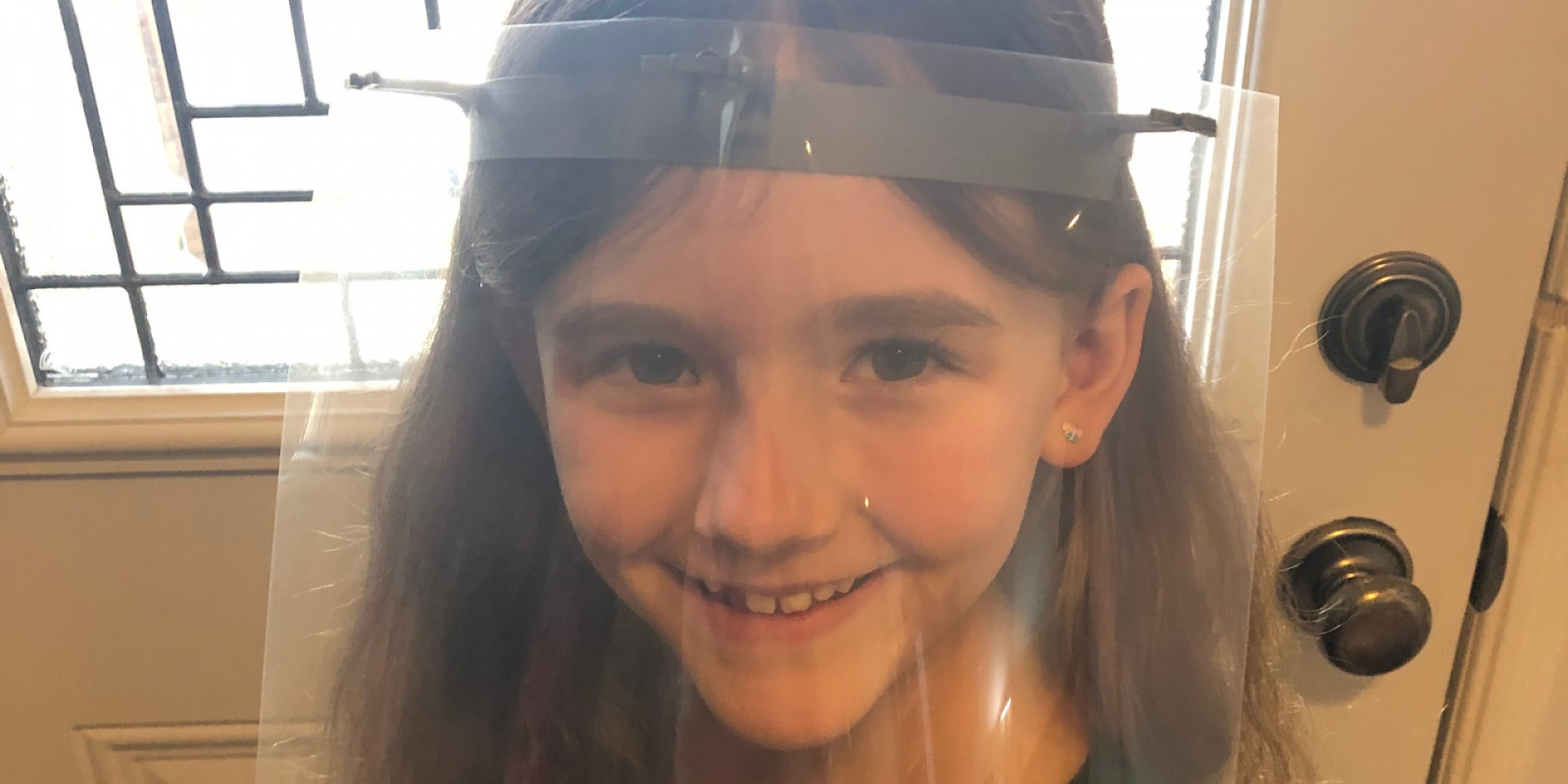 Andrew and Joanne’s daughter models a visor and shield made at home