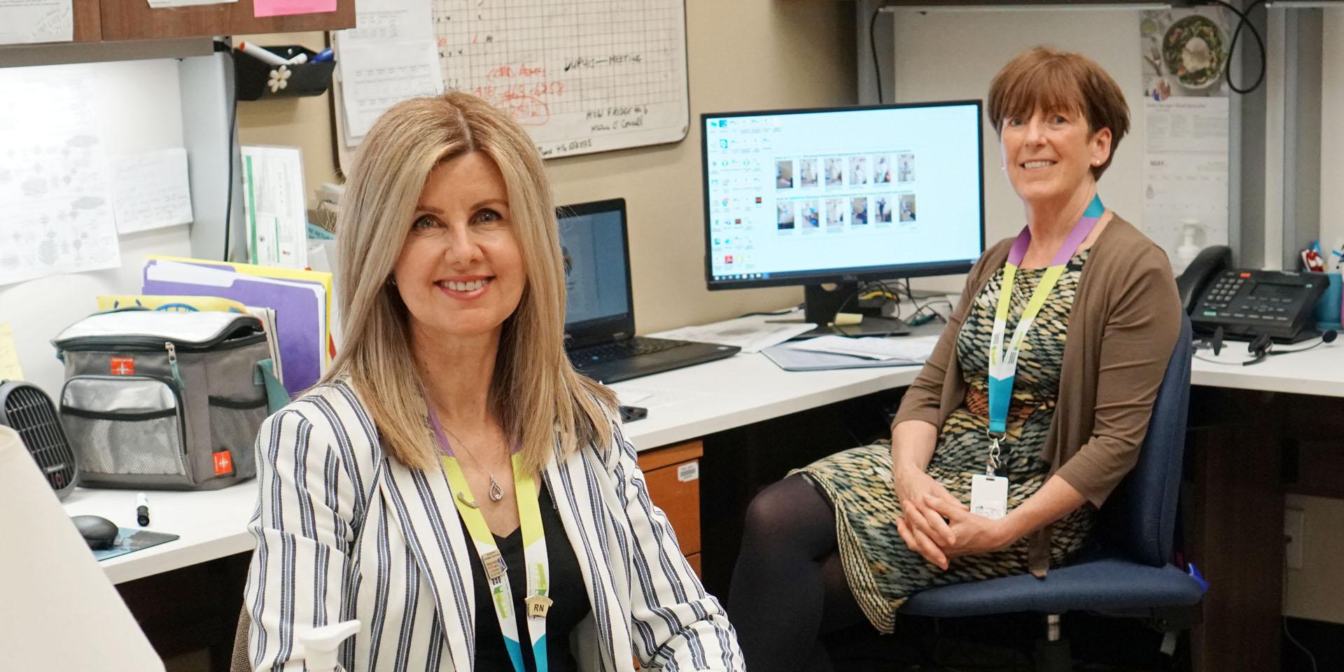 Trudy Ryan-Brady and Mary Fitzgerald sitting at their office computers