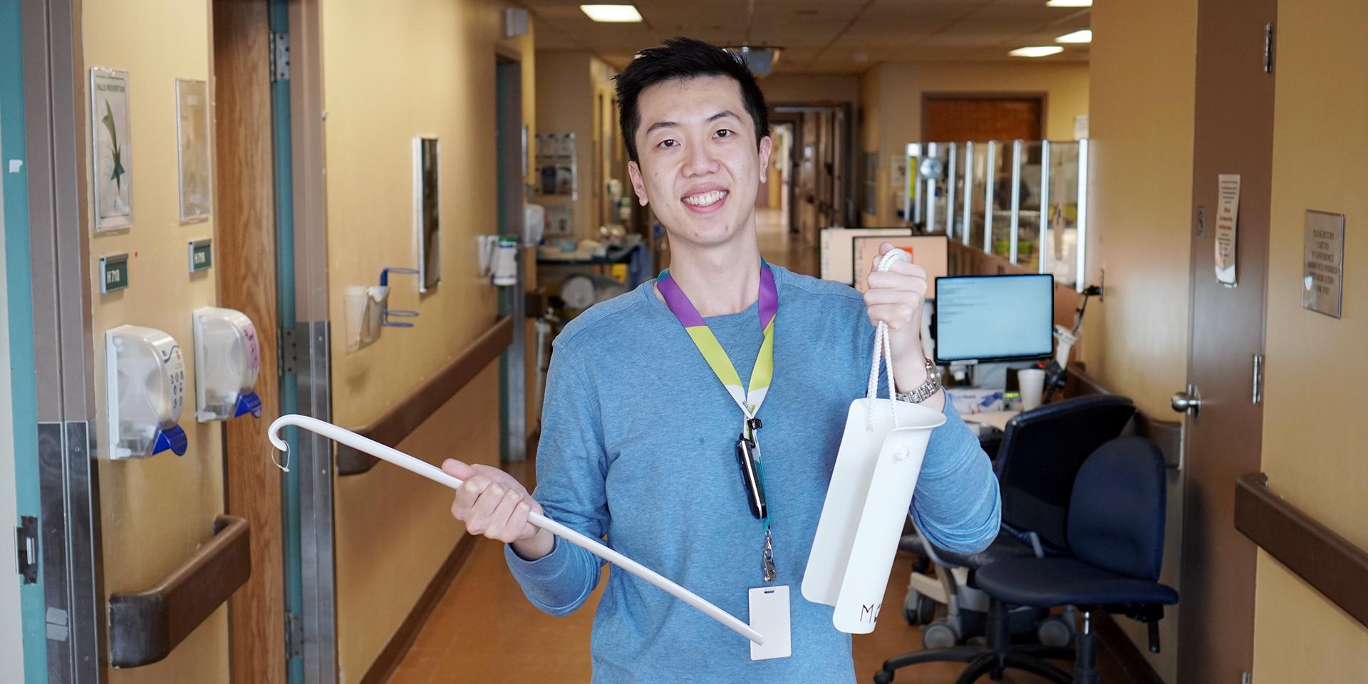 Occupational therapist Jonathan Chiu displays sock aid and long handle shoe horn.