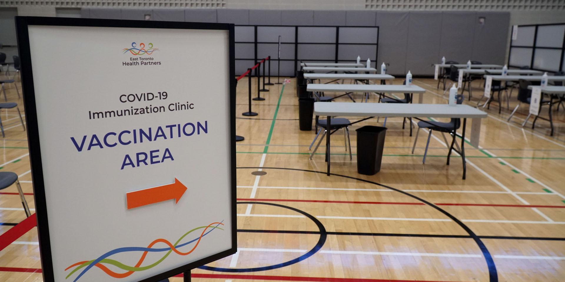 Empty vaccination clinic with tables and chairs