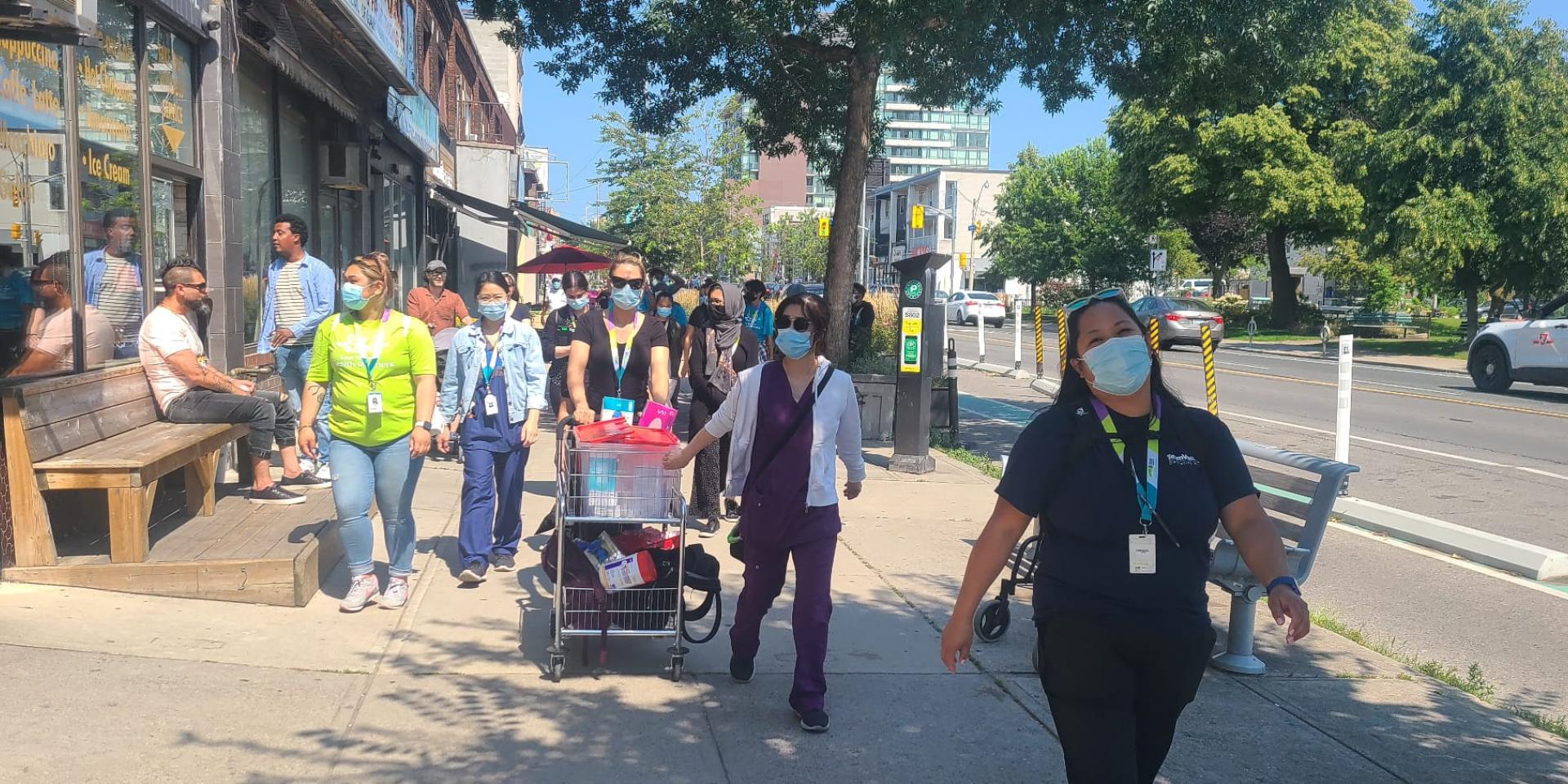Nurses and clerks from ETHP's mobile vaccination team walk along the streets of East Toronto to administer vaccines to residents.