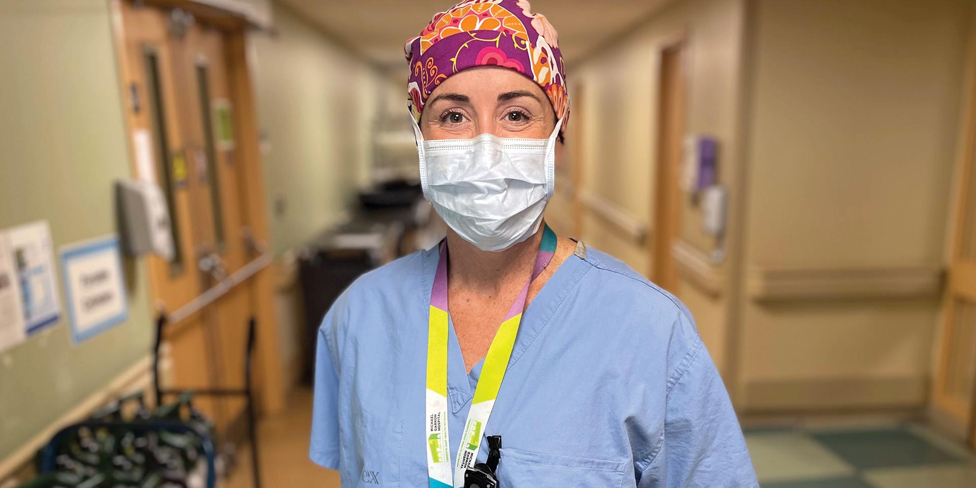 Medical worker wearing scrubs poses for camera