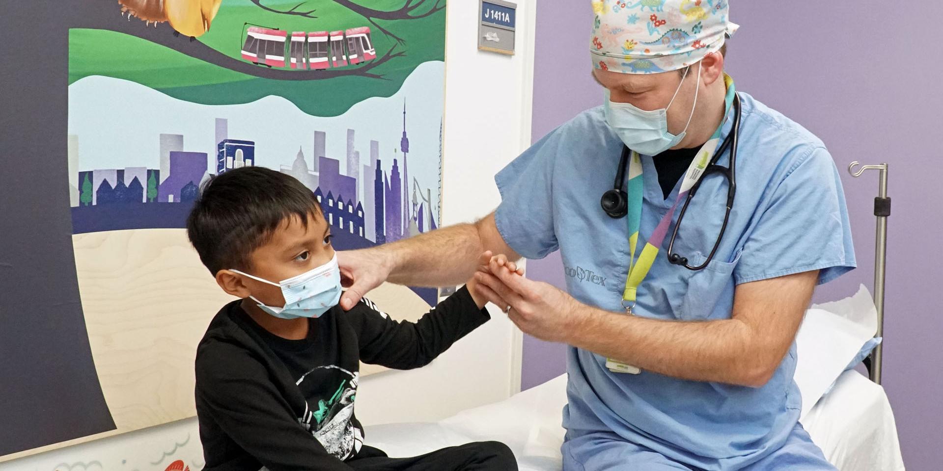 Dr. Charnish assesses a paediatric patient in the Child and Youth Emergency Zone.