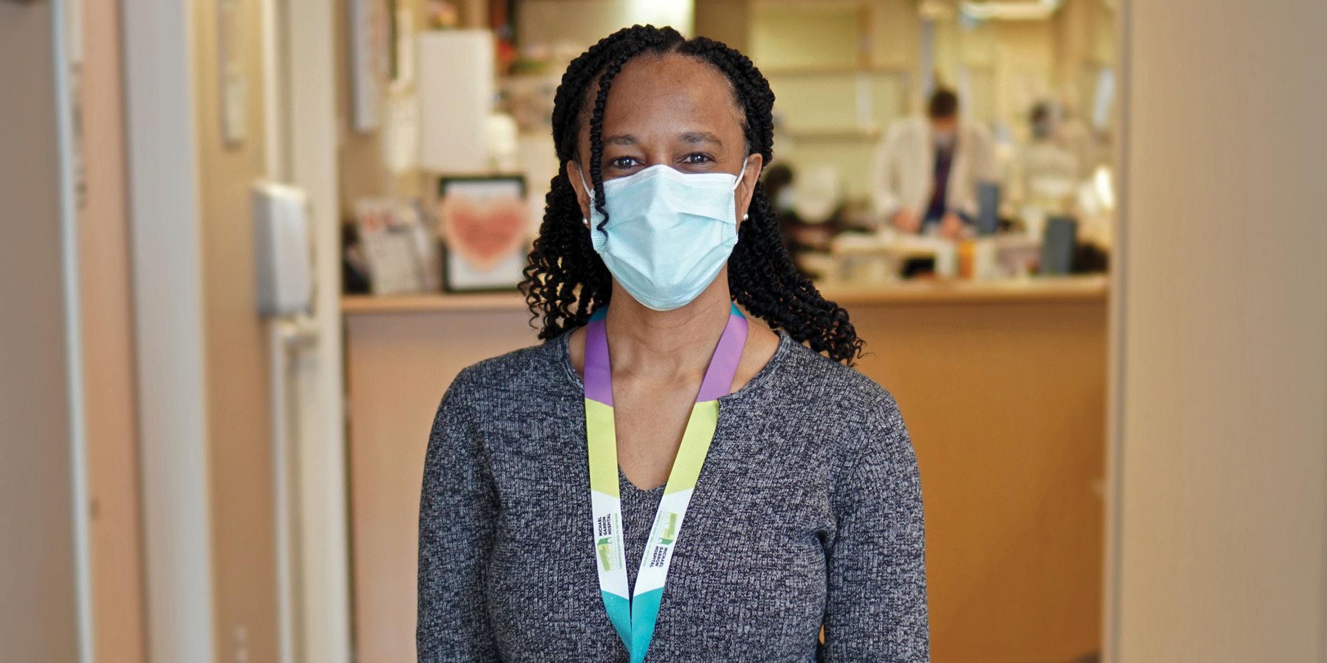 Maxine Castello, manager of renal and oncology programs at MGH, standing in a hallway