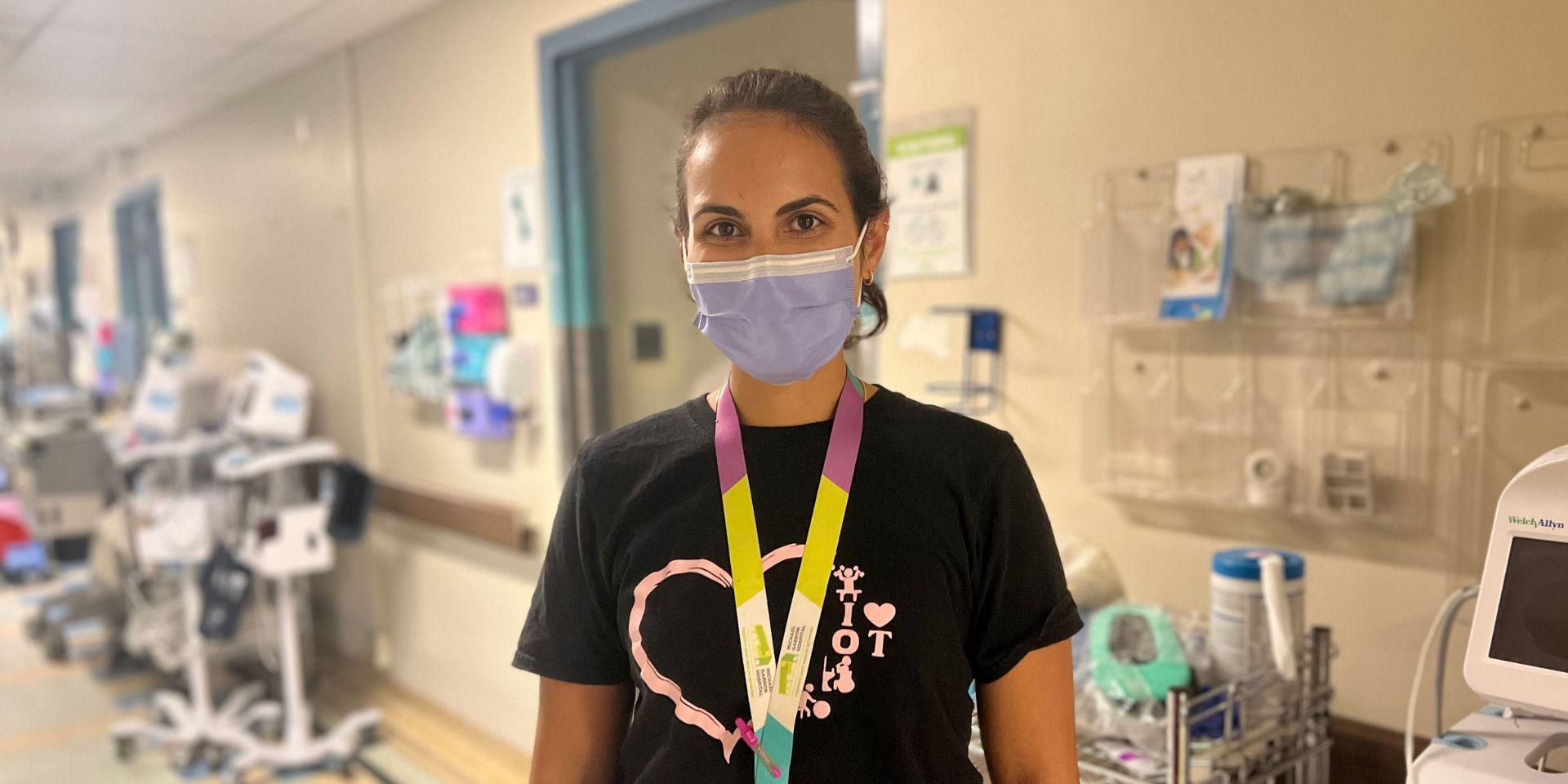 Occupational Therapist, Hanna Grover, standing in hallway with a mask on