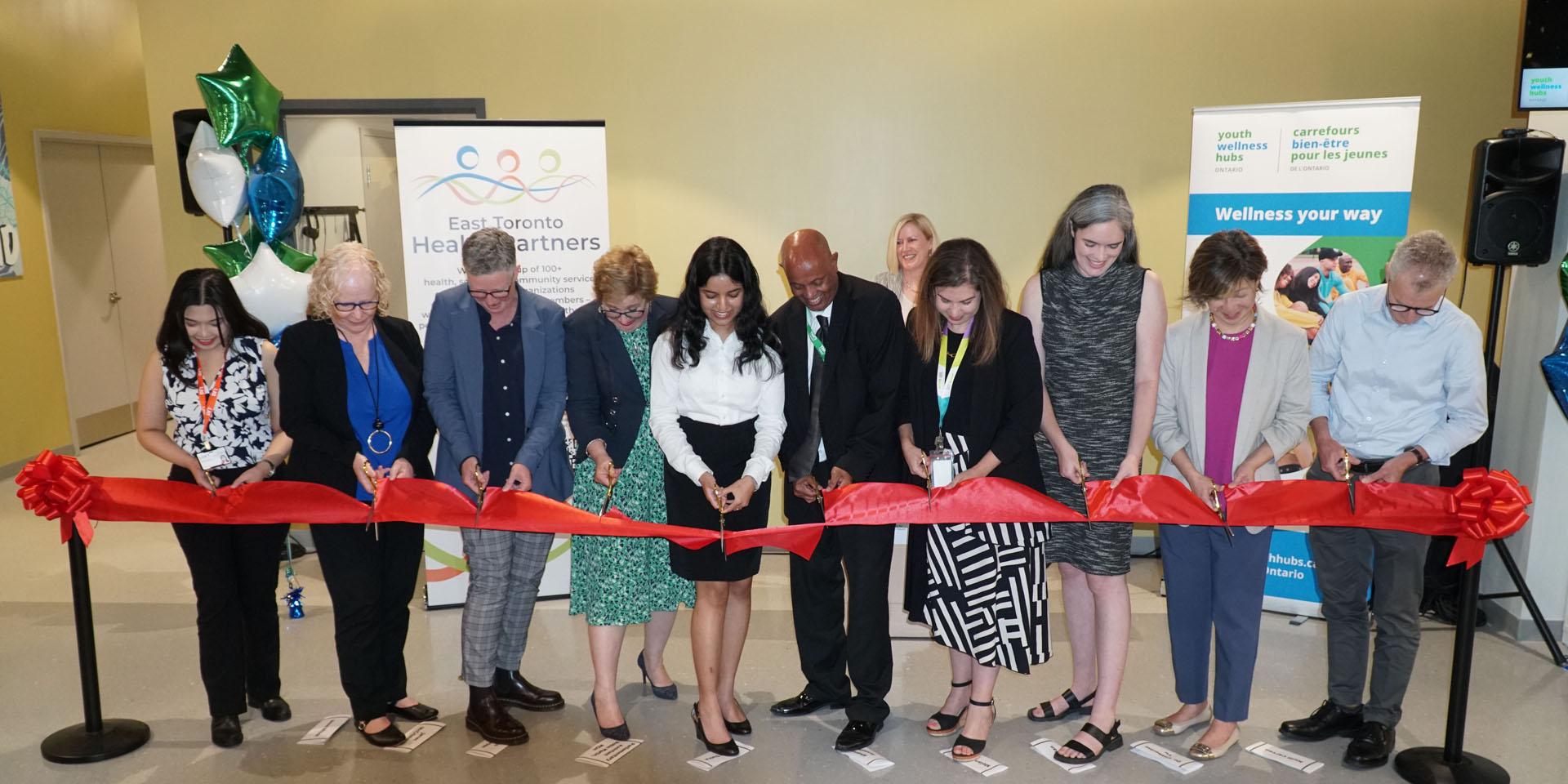 Staff, community members and government representatives participate in a ribbon cutting at the grand opening of the Thorncliffe Park Youth Wellness Hub on July 18.