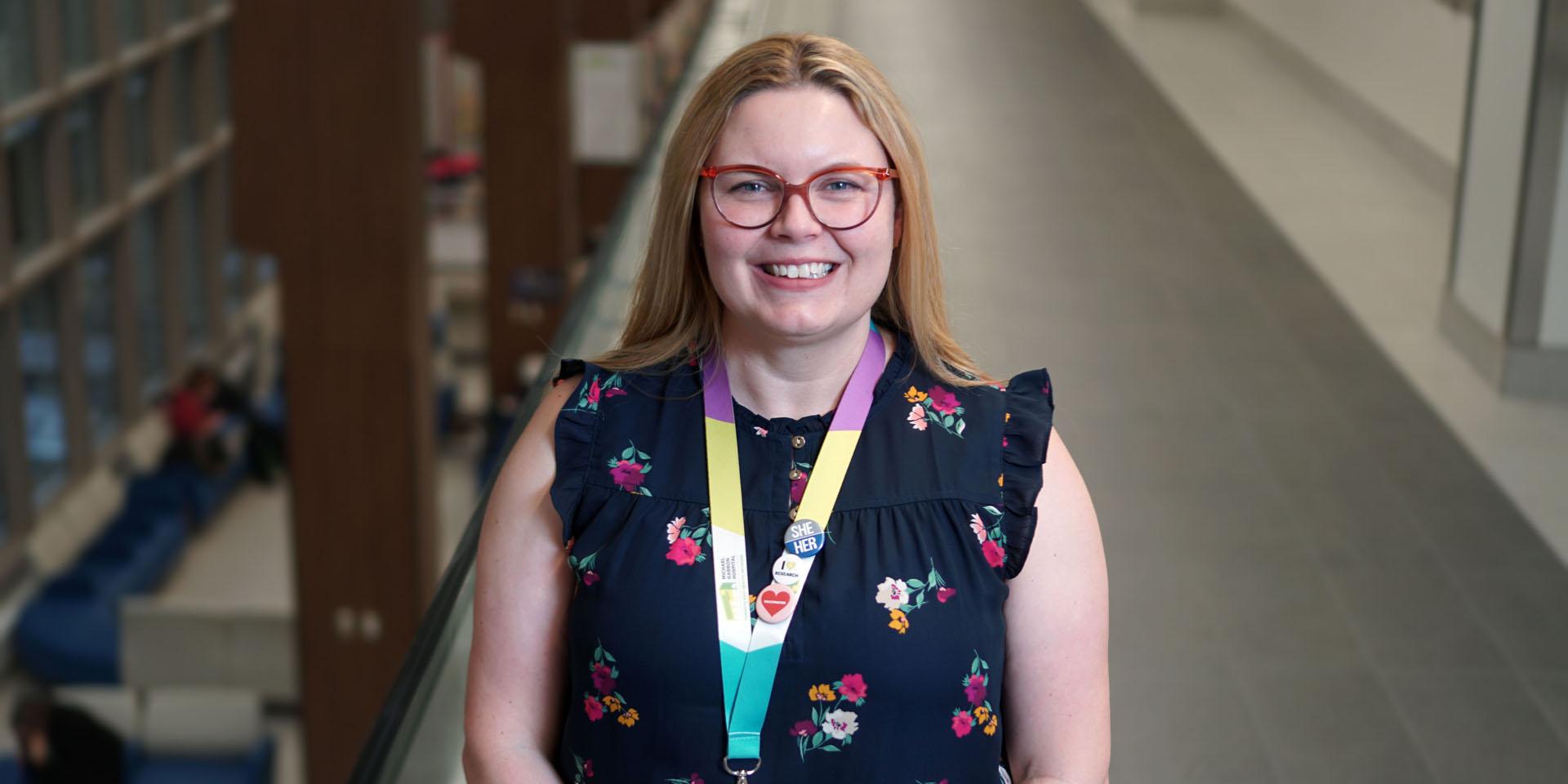 Kristen Currie smiling and standing in a hallway at Michael Garron Hospital.