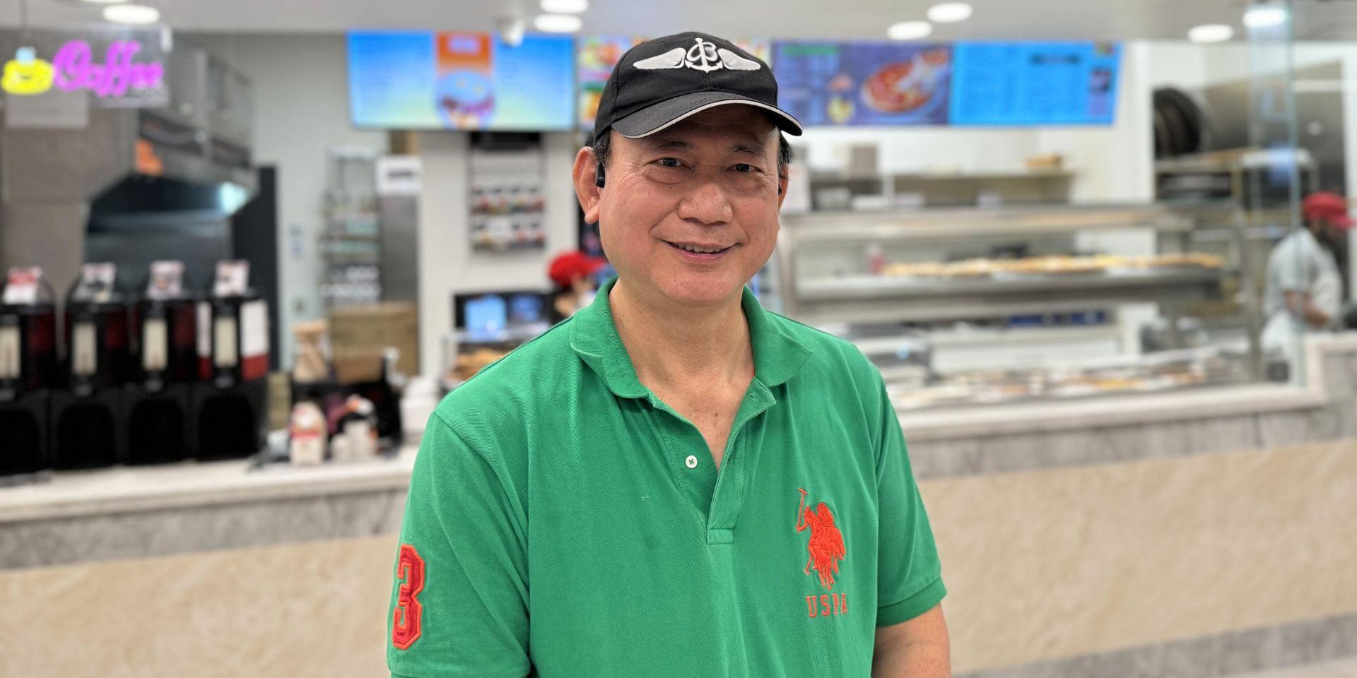 Jack Chen smiling in front of JK Pizza. 