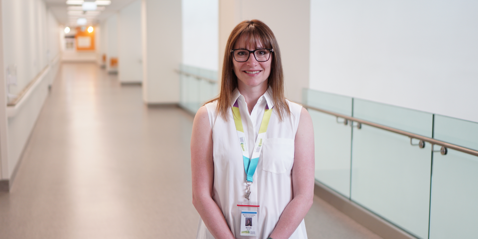 Sarah Wright, Research Scientist, stands in hospital hallway. 