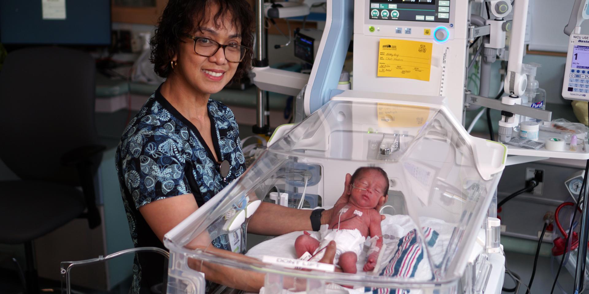 Imelda Macaraeg, Registered Nurse in MGH’s NICU, provides care for a baby.