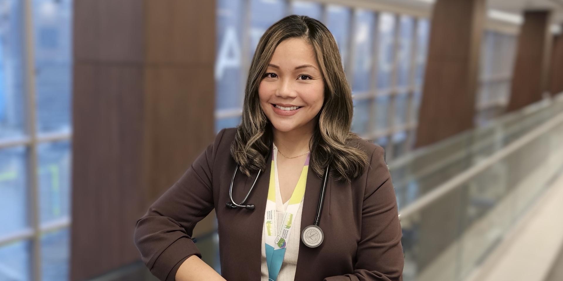 Raychel standing and smiling in MGH hallway. 