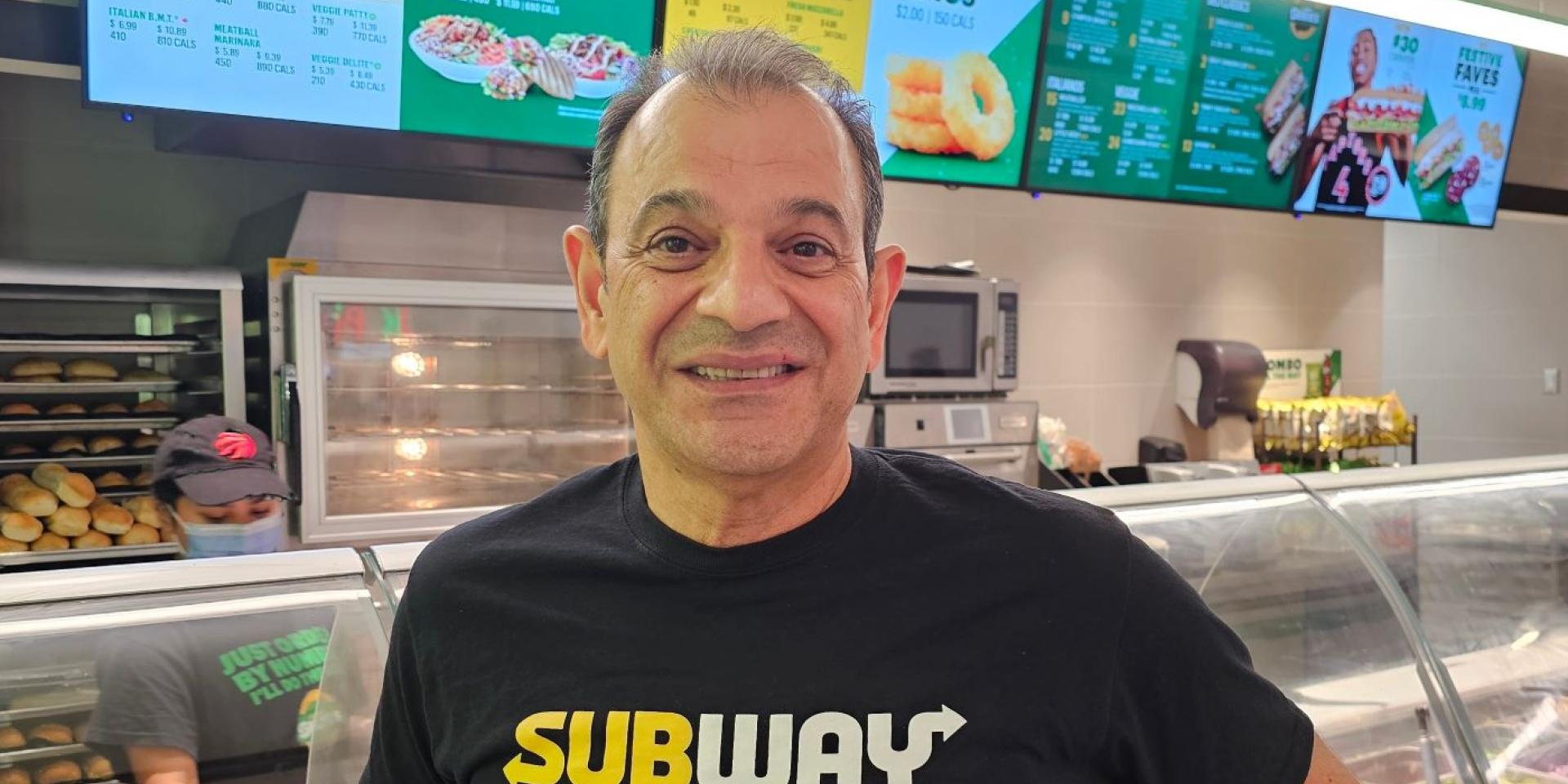 Matt smiling in front of Subway