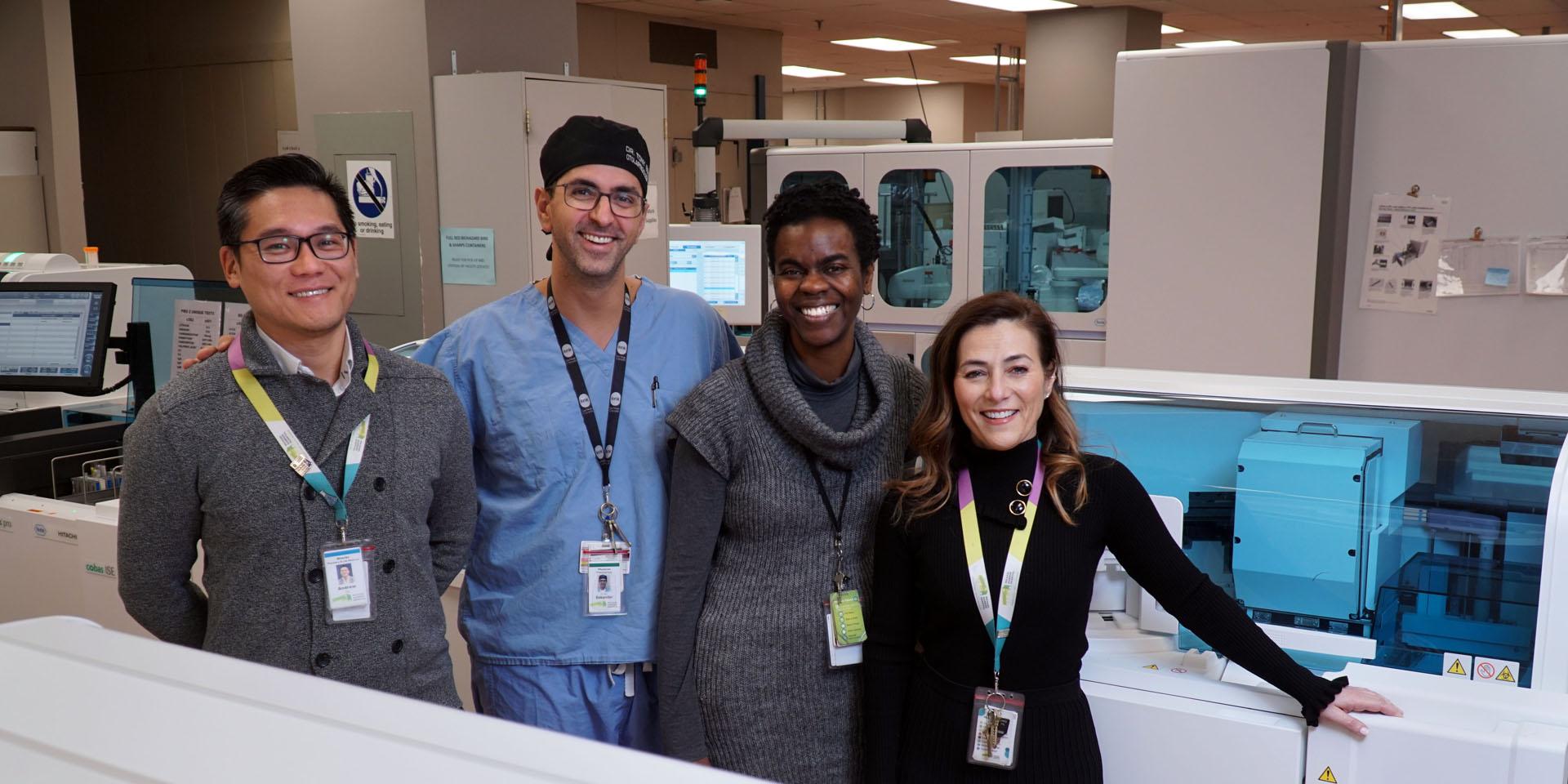 A group of people standing inside a hospital laboratory.