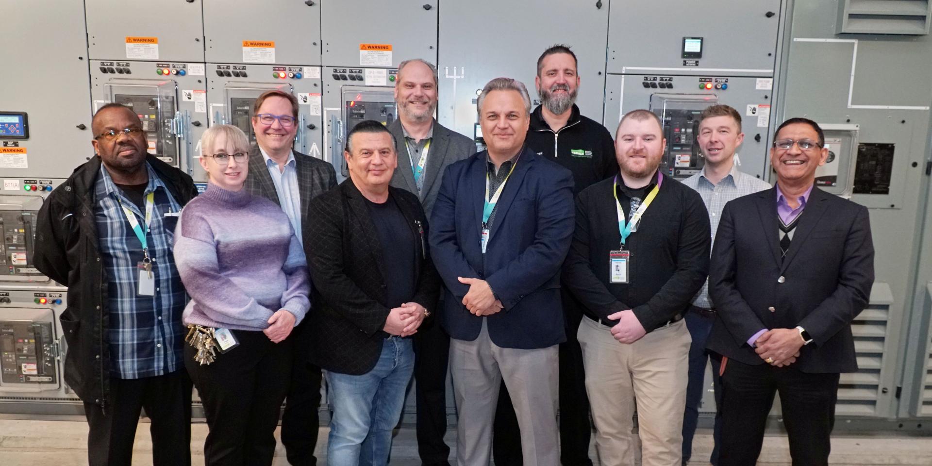 Several staff from MGH stand together and smile at the camera.