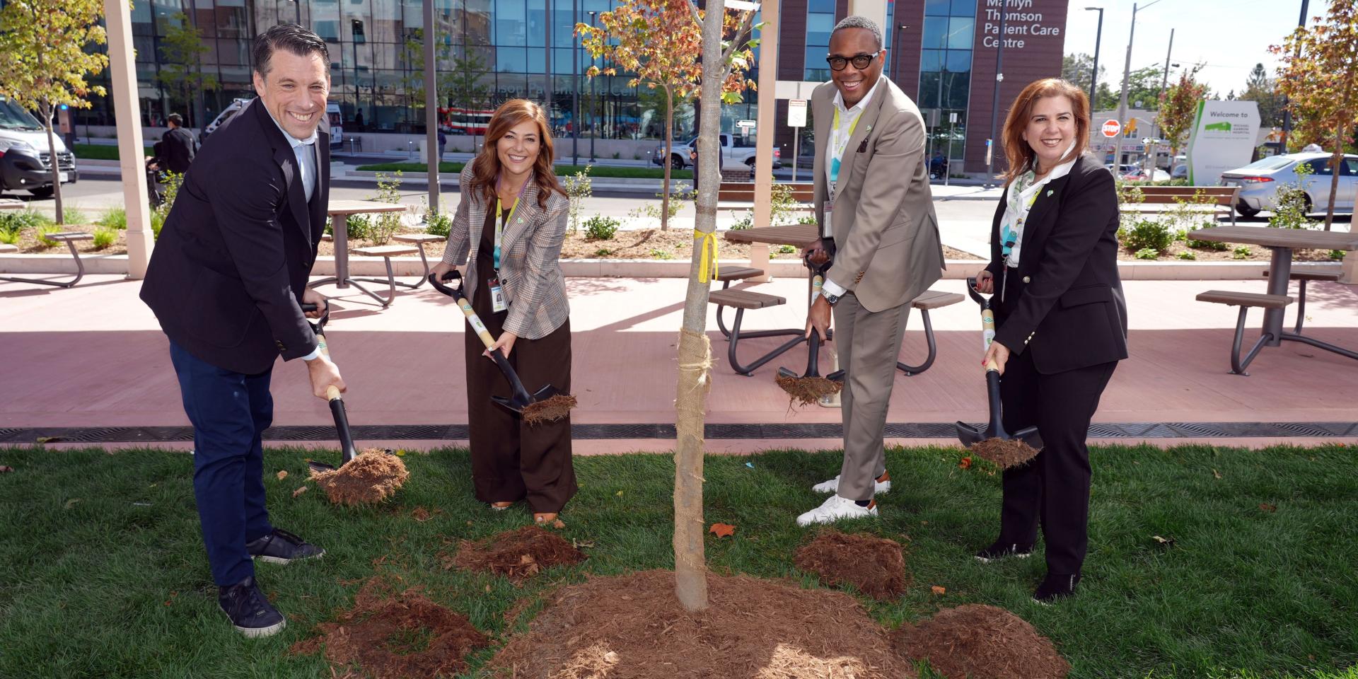 From left: Adrian Rocca, Board Chair, Michael Garron Hospital Foundation; Mitze Mourinho, President, Michael Garron Hospital Foundation; Michael Holder, Board Chair, Michael Garron Hospital; and Melanie Kohn, President and CEO, Michael Garron Hospital at the ceremonial tree planting at the celebration of Coxwell Avenue Opening.