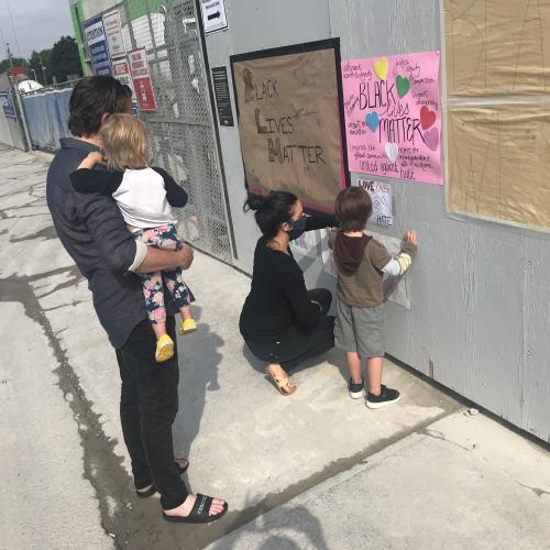 Family putting up Black Lives Matter signage