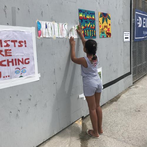 Child posting black lives matter sign