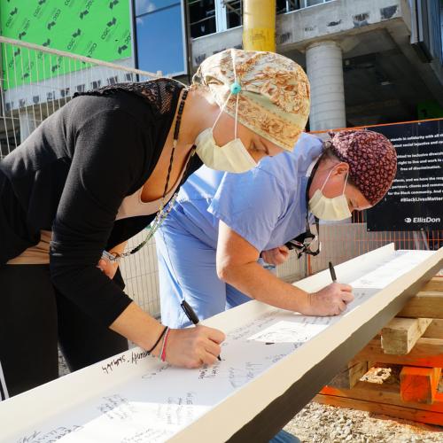 Two staff members signing Unity Beam