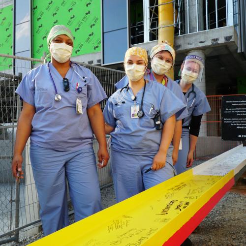 Staff in scrubs standing in front of Unity Beam