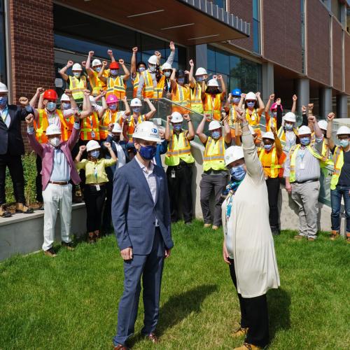 MGH Redevelopment team cheers after Sarah Downey receives the key to the Thomson Centre