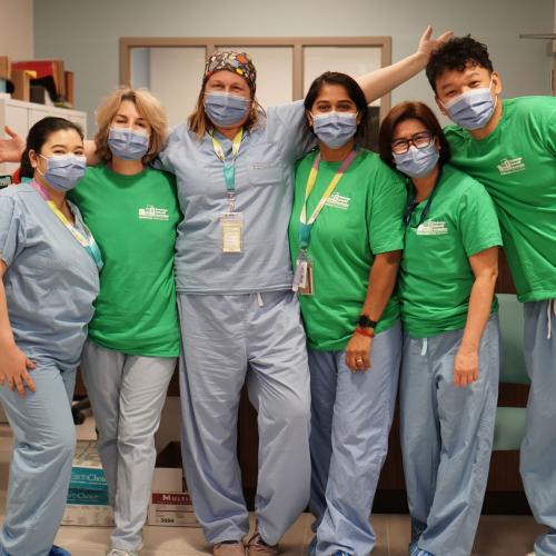 MGH staff standing side by side wearing masks