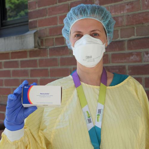 Dr. Mariana Jacubovich, Family Physician in East Toronto and member of East Toronto Family Practice Network, holds a box of Paxlovid pills