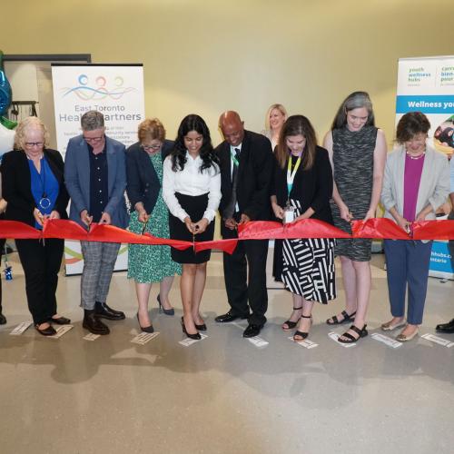 Staff, community members and government representatives participate in a ribbon cutting at the grand opening of the Thorncliffe Park Youth Wellness Hub on July 18.