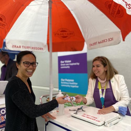 Melanie Kohn hands ice cream to a staff member during the hospital’s staff summer social event in August 2023. 