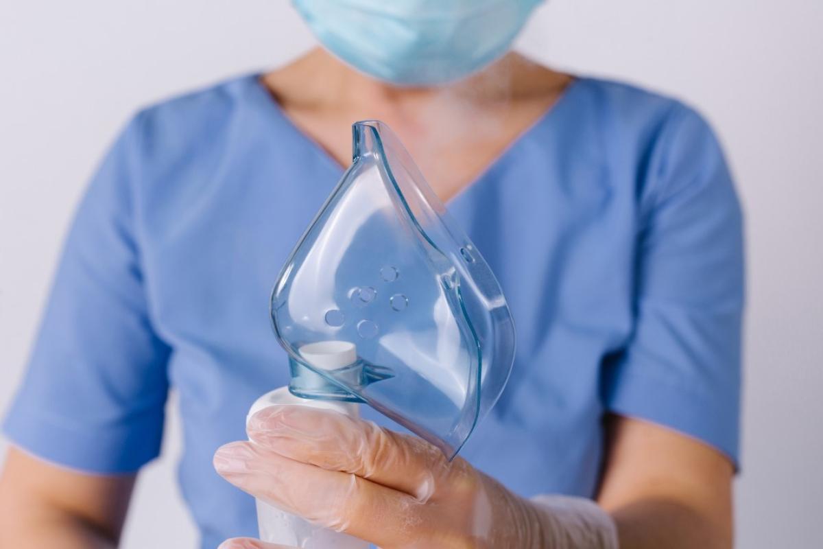 Healthcare worker holds a mask in their hands