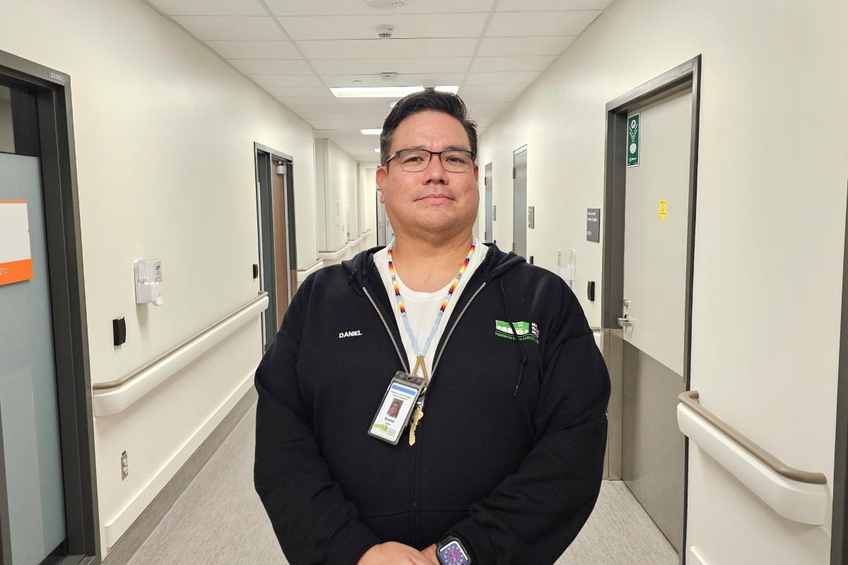 MGH's Indigenous Patient Navigator stands in a hospital hallway