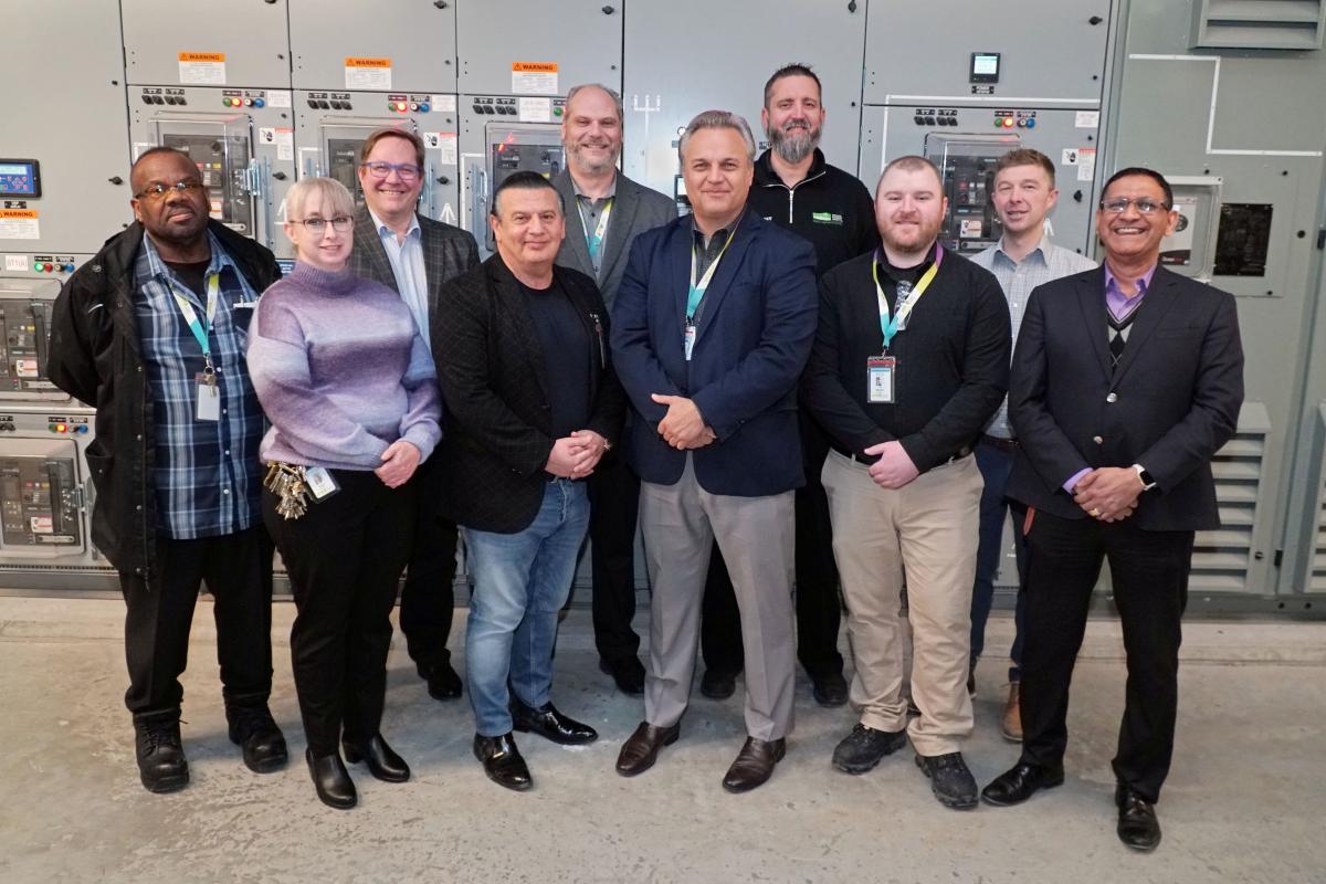 Several staff from MGH stand together and smile at the camera.