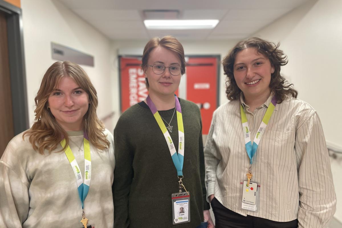 Three members of the Stavro ED peer support team pose in front of the Stavro Emergency Department at Michael Garron Hospital.