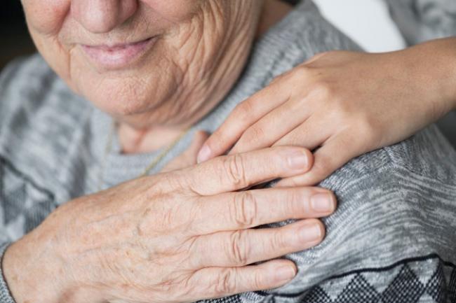 Person putting hand on another person's shoulder