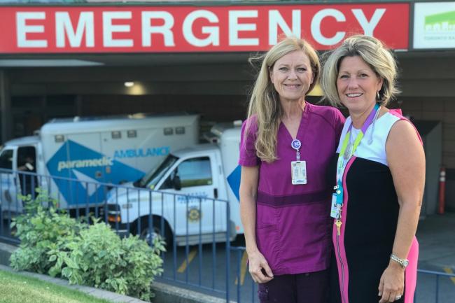 Colleen Young and Irene Andress stand in front of MGH's Emergency Department.