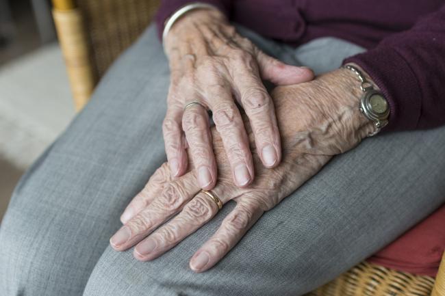 Elderly person sitting in chair 