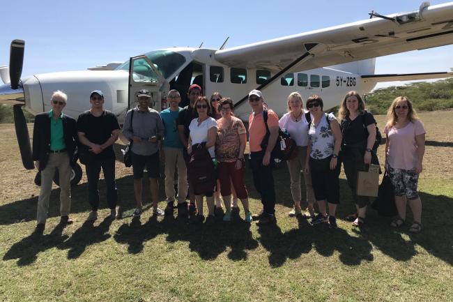 Team in front of airplane