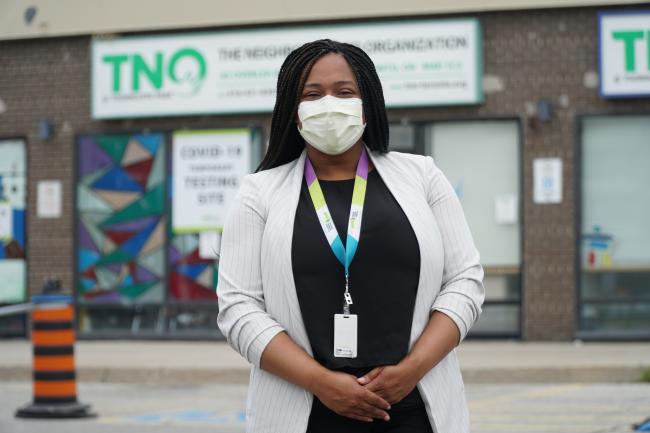 Jennifer Sampson poses outside the pop-up COVID-19 testing site in Thorncliffe Park.