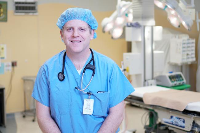 Doctor stands in an operating room.