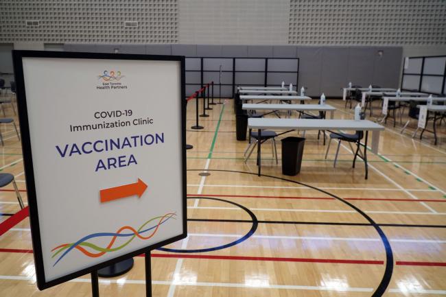 Empty vaccination clinic with tables and chairs