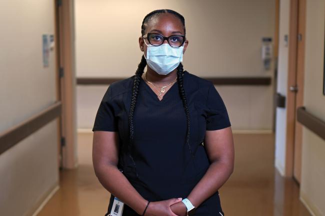 Renae Dixon standing in a hallway posing for her photo