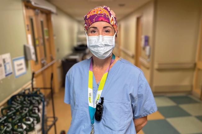 Medical worker wearing scrubs poses for camera