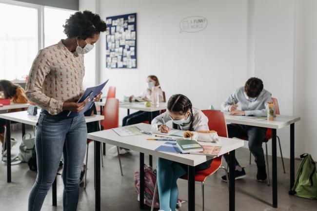 students and teacher in classroom wearing face masks