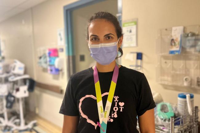 Occupational Therapist, Hanna Grover, standing in hallway with a mask on