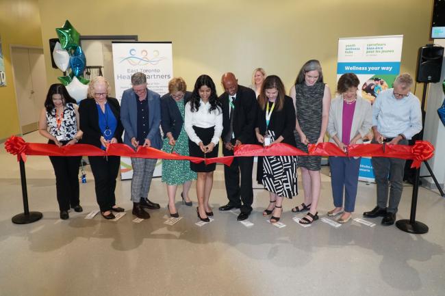 Staff, community members and government representatives participate in a ribbon cutting at the grand opening of the Thorncliffe Park Youth Wellness Hub on July 18.